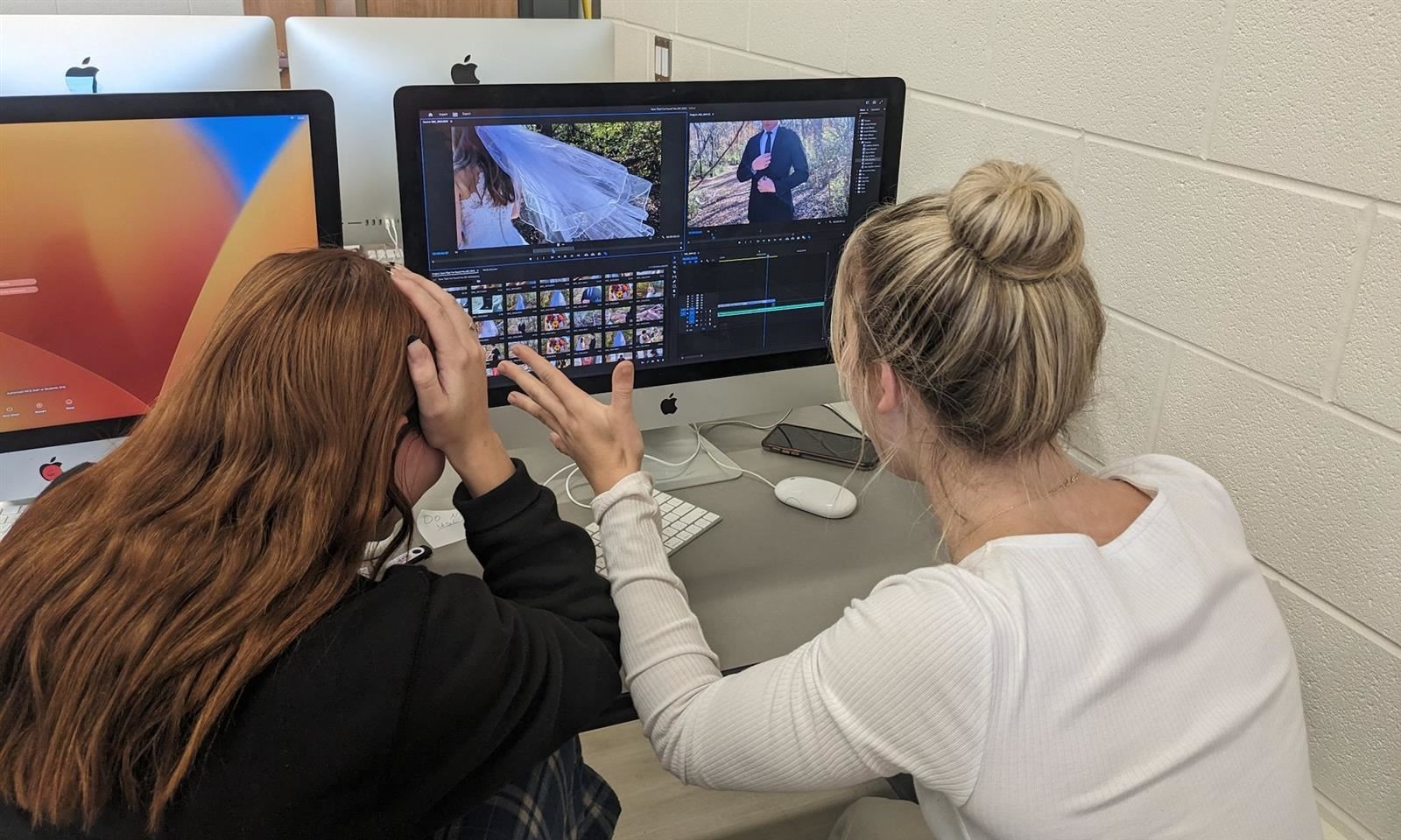 Two girls edit a video